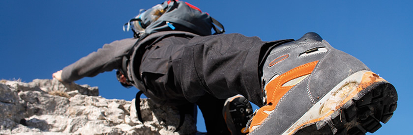 Rock climber with cutting edge equipment tackling a rockface